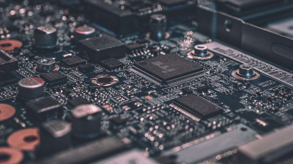 Close view of a microprocessor and circuit board, representing the hardware behind the artificial intelligence boom